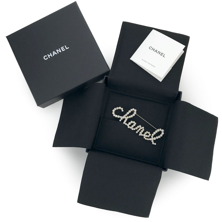 CHANEL Scripted "Chanel" Crystal Pearl Brooch Pin - Dearluxe.com